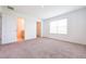 Spacious bedroom features carpet, a large window, and an open doorway to the bathroom at 5345 Tuscany Ln, Davenport, FL 33897