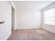 Bright bedroom featuring neutral carpet, a window with blinds, and a closet at 5345 Tuscany Ln, Davenport, FL 33897