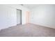 Bedroom with carpet, white walls, closet, and a door to the hallway at 5345 Tuscany Ln, Davenport, FL 33897