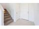 Hallway featuring carpeted stairs, tile flooring, and neutral colored walls at 5345 Tuscany Ln, Davenport, FL 33897