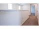 Hallway with neutral carpet and white trim, providing a seamless transition between rooms at 5345 Tuscany Ln, Davenport, FL 33897