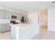 Well-lit kitchen featuring gray cabinets, stainless steel appliances, and a spacious center island at 5345 Tuscany Ln, Davenport, FL 33897