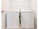 Convenient laundry room featuring a modern, white washer and dryer setup at 5345 Tuscany Ln, Davenport, FL 33897