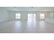 Bright living room featuring light tile flooring and sliding glass doors for ample light at 5345 Tuscany Ln, Davenport, FL 33897