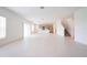 Bright living room showcasing light tile floors, a kitchen, and stairway in an open layout at 5345 Tuscany Ln, Davenport, FL 33897