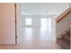 Open living room with white tile flooring, bright natural light, and sliding glass doors at 5345 Tuscany Ln, Davenport, FL 33897