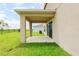Covered outdoor patio with large grassy yard and view of additional green space at 5345 Tuscany Ln, Davenport, FL 33897