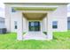 Covered patio, sliding glass doors, green lawn perfect for outdoor relaxation and entertaining at 5345 Tuscany Ln, Davenport, FL 33897