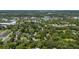 Expansive aerial view showcasing the neighborhood with lush greenery and local area at 608 Cedar Ave, Holly Hill, FL 32117