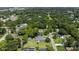 An aerial view shows the home nestled in a lush, green, tree-filled neighborhood at 608 Cedar Ave, Holly Hill, FL 32117