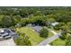 An aerial view shows the home nestled in a lush, green, tree-filled neighborhood at 608 Cedar Ave, Holly Hill, FL 32117