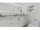 Bathroom featuring a lighted mirror, double sink vanity, and toilet at 608 Cedar Ave, Holly Hill, FL 32117