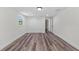 Bedroom featuring wood-look floors, closet, and bright window at 608 Cedar Ave, Holly Hill, FL 32117