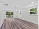 Bedroom with wood-look floors and sliding glass door to deck at 608 Cedar Ave, Holly Hill, FL 32117