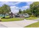 Landscaped front yard with a well manicured lawn leading to a lovely home featuring a brick chimney at 608 Cedar Ave, Holly Hill, FL 32117