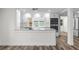 Modern kitchen with white cabinets, stainless steel appliances, and granite countertop at 608 Cedar Ave, Holly Hill, FL 32117