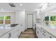 Bright kitchen with white cabinets, marble countertops, farmhouse sink, and stainless appliances at 608 Cedar Ave, Holly Hill, FL 32117