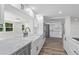 Open kitchen featuring white cabinets, marble countertops, stainless appliances, and wood-look floors at 608 Cedar Ave, Holly Hill, FL 32117