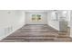 Open-concept living area with wood-look floors and natural light at 608 Cedar Ave, Holly Hill, FL 32117