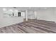Open living space showcasing new floors connecting to kitchen and dining area at 608 Cedar Ave, Holly Hill, FL 32117