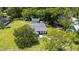 Rear aerial view of home showcasing the backyard, additional building, and mature trees at 608 Cedar Ave, Holly Hill, FL 32117