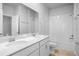 A well-lit bathroom features a dual sink vanity, a large mirror and combination shower and bathtub at 6449 Sprucepine Ln, St Cloud, FL 34771