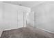 Neutral bedroom with plush carpet featuring two doorways and white doors at 6449 Sprucepine Ln, St Cloud, FL 34771