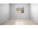 Bedroom featuring a large window with blinds and neutral colored flooring at 6449 Sprucepine Ln, St Cloud, FL 34771