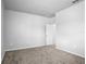 This bedroom has carpet and neutral walls with a doorway leading to another room and light switches on the walls at 6449 Sprucepine Ln, St Cloud, FL 34771
