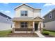 Charming two-story home with stone accents, covered porch, and landscaped front yard at 6449 Sprucepine Ln, St Cloud, FL 34771