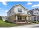 Beautiful two-story home with a cozy front porch and lush green lawn in a residential neighborhood at 6449 Sprucepine Ln, St Cloud, FL 34771
