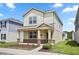 Inviting two-story home featuring a covered porch with stone accents and well-manicured lawn at 6449 Sprucepine Ln, St Cloud, FL 34771