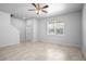 Spacious living room featuring tile flooring, a ceiling fan, and a staircase leading to the second floor at 6449 Sprucepine Ln, St Cloud, FL 34771