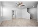 Open-concept living room with tile flooring, ceiling fan, and seamless flow to the kitchen at 6449 Sprucepine Ln, St Cloud, FL 34771