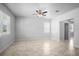 Bright, airy living room with tile flooring, ceiling fan, and natural light from multiple windows at 6449 Sprucepine Ln, St Cloud, FL 34771