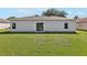 Backyard showing a view of the home's exterior and manicured green lawn at 702 Pasteur Ln, Kissimmee, FL 34759