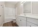 Bathroom featuring a white vanity, framed mirror, and a shower-tub combination at 702 Pasteur Ln, Kissimmee, FL 34759