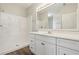 Bathroom featuring a walk-in shower, vanity, and large mirror at 702 Pasteur Ln, Kissimmee, FL 34759