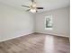 A spacious bedroom is bright and open, featuring a ceiling fan and window at 702 Pasteur Ln, Kissimmee, FL 34759