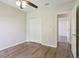 Bedroom featuring a closet, wood-look floors, a ceiling fan and a hallway entrance at 702 Pasteur Ln, Kissimmee, FL 34759