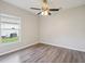 Bedroom features include ceiling fan, wood-look floors and a window for natural light at 702 Pasteur Ln, Kissimmee, FL 34759