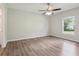 A spacious bedroom is bright and open, featuring a ceiling fan and window at 702 Pasteur Ln, Kissimmee, FL 34759