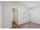 Bright bedroom featuring modern wood-look floors, closet and a window at 702 Pasteur Ln, Kissimmee, FL 34759