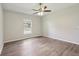 Bedroom is bright and open, featuring a ceiling fan and window at 702 Pasteur Ln, Kissimmee, FL 34759