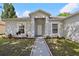 Inviting front entrance with a walkway and beautiful landscaping at 702 Pasteur Ln, Kissimmee, FL 34759
