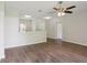 Bright living room featuring modern wood-look floors and a ceiling fan at 702 Pasteur Ln, Kissimmee, FL 34759