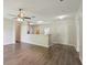 Spacious living room with modern wood-look flooring and a ceiling fan at 702 Pasteur Ln, Kissimmee, FL 34759