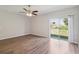 Bright living room featuring modern wood-look floors and a sliding glass door at 702 Pasteur Ln, Kissimmee, FL 34759
