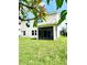 Spacious backyard featuring a screened lanai, lush green grass, and mature trees at 813 Marsh Reed Dr, Winter Garden, FL 34787