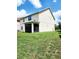Expansive backyard showcasing a screened lanai, well-maintained lawn, and mature trees at 813 Marsh Reed Dr, Winter Garden, FL 34787